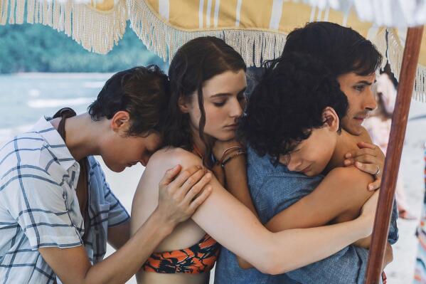 This image released by Universal Pictures shows, from left, Vicky Krieps, Thomasin McKenzie, Gael García Bernal and Luca Faustino Rodriguez in a scene from "Old." (Universal Pictures via AP)