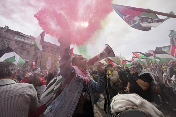 A protester shouts into a megaphone during a Pro-Palestinian demonstration for excluding Israel from Eurovision ahead of the second semi-final at the Eurovision Song Contest in Malmo, Sweden, Thursday, May 9, 2024. (AP Photo/Martin Meissner)