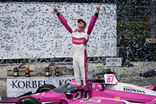 Kyle Kirkwood celebrates during the victory ceremony after winning the IndyCar Grand Prix of Long Beach auto race, Sunday, April 16, 2023, in Long Beach, Calif. (AP Photo/Jae C. Hong)