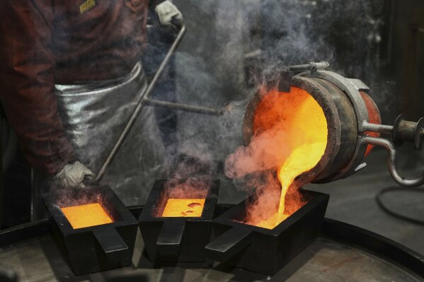 A work pours unrefined liquid gold into casts at the ABC Refinery smelter in Sydney, Australia, Wednesday, April 30, 2025. (AP Photo/Mark Baker)