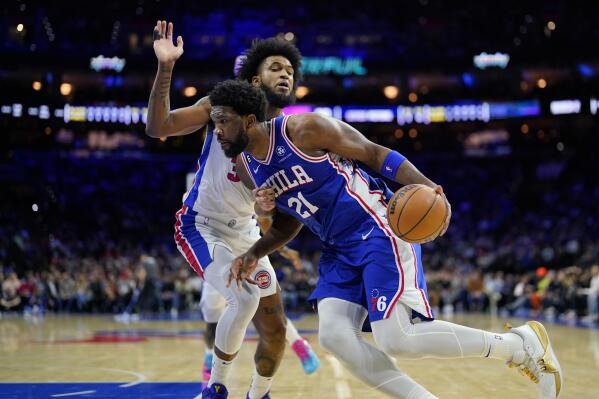 Philadelphia 76ers' Joel Embiid, right, tries to get past Detroit Pistons' Marvin Bagley III during the first half of an NBA basketball game, Wednesday, Dec. 21, 2022, in Philadelphia. (AP Photo/Matt Slocum)