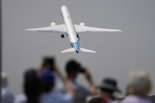 FILE - A Boeing 777X plane takes off at the Farnborough Air Show fair in Farnborough, England, on July 18, 2022. The cost of your next flight is likely to go up. That's the word from the International Air Transport Association, which held its annual meeting Monday June 3, 2024 in Dubai, home to the long-haul carrier Emirates. (AP Photo/Frank Augstein, File)