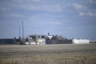 FILE - This April 18, 2020, file photo, shows the JBS USA Pork Plant in Worthington, Minn. Officials estimate that about 700,000 pigs across the nation can't be processed each week and must euthanized. Most of the hogs are being killed at farms, but up to 13,000 a day also may be euthanized at the JBS pork plant in Worthington. (Aaron Lavinsky/Star Tribune via AP)