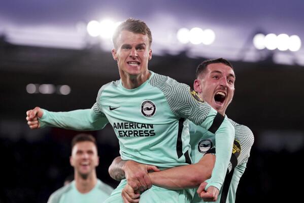 Brighton's Solly March, centre, celebrates with his team mates after scoring his sides third goal of the game during the Premier League soccer match between Southampton and Brighton, at St. Mary's Stadium in Southampton, England, Monday Dec. 26, 2022. (Adam Davy/PA via AP)