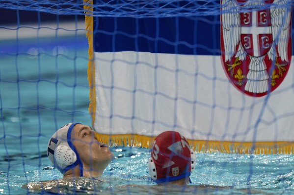 Serbia's Petar Jaksic celebrates winning the men's water polo gold medal match against Croatia, at the 2024 Summer Olympics, Sunday, Aug. 11, 2024, in Paris, France. (AP Photo/Luca Bruno)