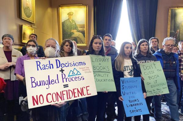 Students from some Vermont State Colleges, along with others, display signs Tuesday, Feb. 21, 2023, at the Statehouse in Montpelier, Vt., while protesting a decision by the schools' administration to shift to an an all-digital library for three of the schools. The Vermont State Colleges System, which has struggled financially for years, announced early this month that the the library of the new Vermont State University, which will be comprised of three state colleges, will shift to an all-digital format, effective July 1. (AP Photo/Lisa Rathke)