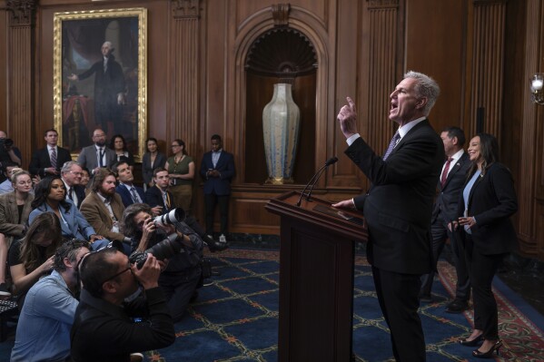 Speaker of the House Kevin McCarthy, R-Calif., pauses as he addresses reporters about efforts to pass appropriations bills and avert a looming government shutdown, at the Capitol in Washington, Friday, Sept. 29, 2023. He is joined at right by House Homeland Security Chair Mark Green, R-Tenn., and Rep. Monica de la Cruz, R-Texas. (AP Photo/J. Scott Applewhite)