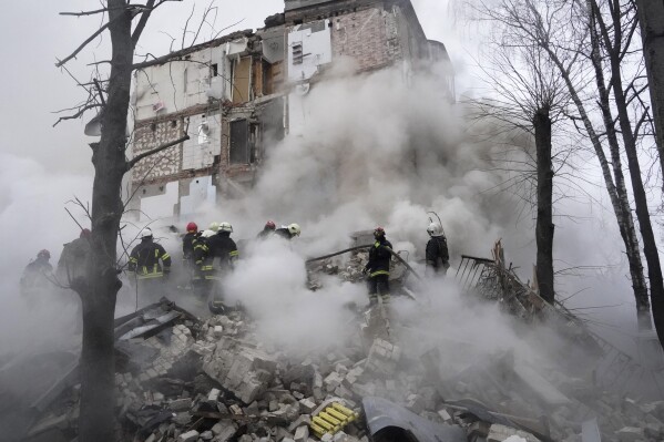 Rescuers work at the scene of a building damaged by Russian rocket attack in Kharkiv, Ukraine, Tuesday, Jan. 23, 2024. (APPhoto/Andrii Marienko)