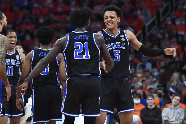 Duke forward Paolo Banchero (5) celebrates with forward AJ Griffin (21) after scoring against Syracuse during the first half of an NCAA college basketball game in Syracuse, N.Y., Saturday, Feb. 26, 2022. (AP Photo/Adrian Kraus)