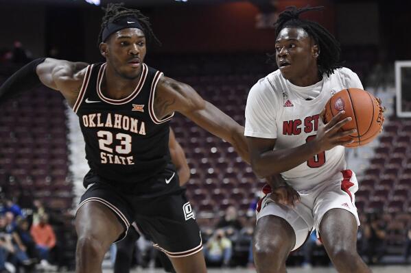 Oklahoma State's Tyreek Smith (23) guards North Carolina State's Cam Hayes (3) in the first half of an NCAA college basketball game, Wednesday, Nov. 17, 2021, in Uncasville, Conn. (AP Photo/Jessica Hill)