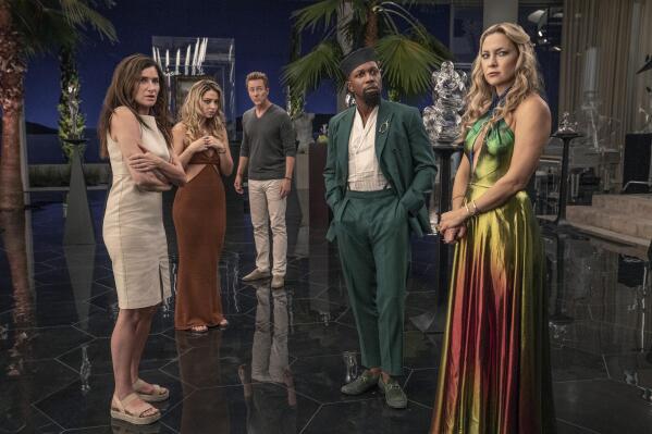 This image released by Netflix shows Kathryn Hahn, from left, Madelyn Cline, Edward Norton, Leslie Odom Jr. and Kate Hudson in a scene from "Glass Onion: A Knives Out Mystery."  (John Wilson/Netflix via AP)