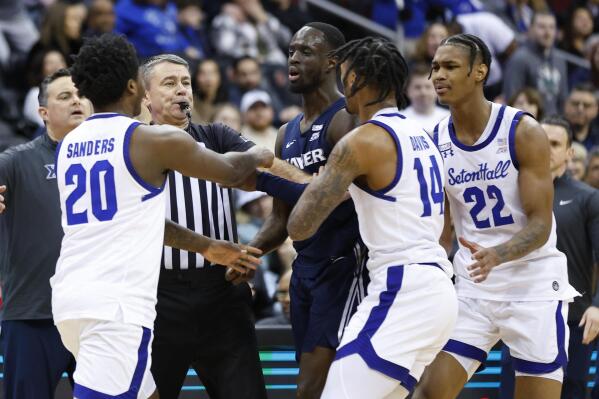 An official steps in to break up a scuffle between Seton Hall guard Jaquan Sanders (20) and Xavier guard Souley Boum during the second half of an NCAA college basketball game in Newark, N.J., Friday, Feb. 24, 2023. (AP Photo/Noah K. Murray)