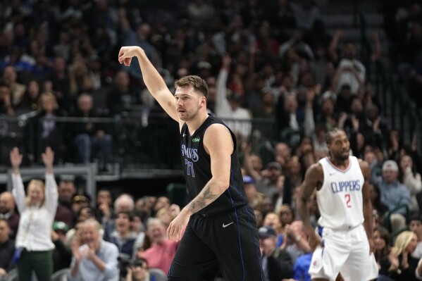 Dallas Mavericks guard Luka Doncic (77) reacts after hitting a 3-point basket against Los Angeles Clippers forward Kawhi Leonard during the first half of an NBA basketball game in Dallas, Friday, Nov. 10, 2023. (AP Photo/LM Otero)