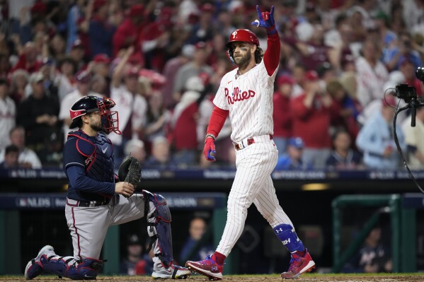 Philadelphia Phillies' Bryce Harper reacts after hitting a home run during the fifth inning of Game 3 of a baseball NL Division Series against the Atlanta Braves Wednesday, Oct. 11, 2023, in Philadelphia. (AP Photo/Matt Slocum)