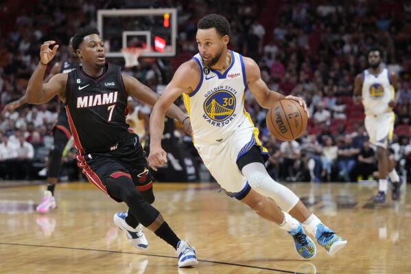 Golden State Warriors guard Stephen Curry (30) drives to the basket past Miami Heat guard Kyle Lowry (7) during the first half of an NBA basketball game, Tuesday, Nov. 1, 2022, in Miami. (AP Photo/Wilfredo Lee)