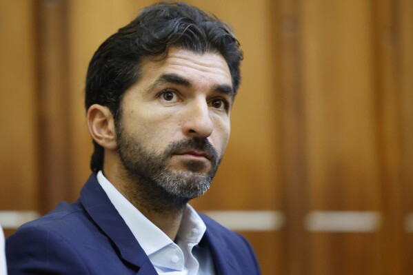 Ohad Fisherman, friend of the Alexander brothers, who are accused of sexual assault, watches the proceedings in Miami-Dade Circuit Court Judge Lody Jean's, courtroom at the criminal courthouse in Miami, Wednesday, Dec. 18, 2024. (Al Diaz/Miami Herald via AP, Pool)