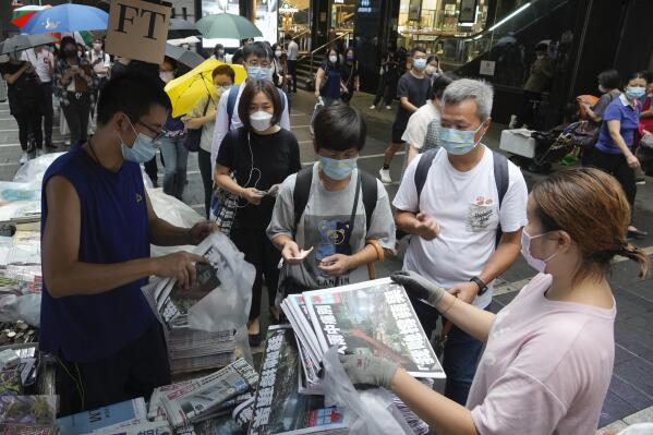 People queue up for last issue of Apple Daily at a newspaper booth at a downtown street in Hong Kong, Thursday, June 24, 2021. Hong Kong's sole remaining pro-democracy newspaper has published its last edition. Apple Daily was forced to shut down Thursday after five editors and executives were arrested and millions of dollars in its assets were frozen as part of China's increasing crackdown on dissent in the semi-autonomous city. ( AP Photo/Vincent Yu)