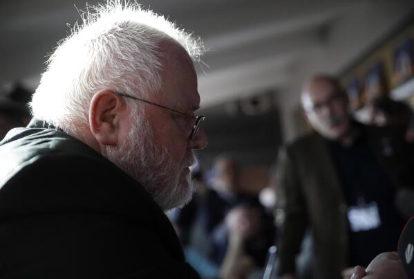 FILE - In this Feb. 22, 2019 file photo, Cardinal Reinhard Marx, left, listens to sex abuse survivor Jean-Marie Fuerbringer, from Switzerland, as he meets member of the ECA (Ending Clergy Abuse), in Rome, Italy. One of Germany’s most prominent Catholic archbishops, in a letter Marx has offered his resignation to Pope Francis. He cited the church’s handling of sexual abuse scandals as one reason he wants to step down and said the church had arrived at “a dead point.” (AP Photo/Alessandra Tarantino)