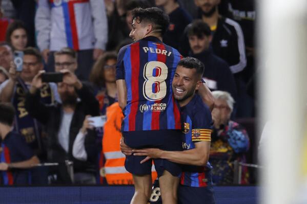 Barcelona's Jordi Alba, right, celebrates after scoring his side's opening goal during a Spanish La Liga soccer match between Barcelona and Osasuna at the Camp Nou stadium in Barcelona, Spain, Tuesday, May 2, 2023. (AP Photo/Joan Monfort)