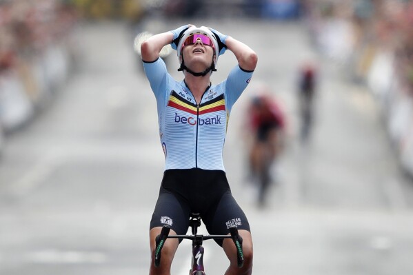 Belgium's Lotte Kopecky celebrates winning the Women's Elite Road Race during day eleven of the 2023 UCI Cycling World Championships in Glasgow, Britain, Sunday Aug.13, 2023. (Will Matthews/PA via AP)