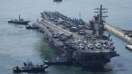 FILE - The U.S. carrier USS Ronald Reagan is escorted as it arrives in Busan, South Korea on Sept. 23, 2022. The American aircraft carrier was due to make a port call in Vietnam on Sunday, June 25, 2023, a rare visit by one of the U.S. Navy's biggest ships that comes as Washington and Beijing both are stepping up efforts to bolster ties with Southeast Asian nations. (AP Photo/Lee Jin-man, File)