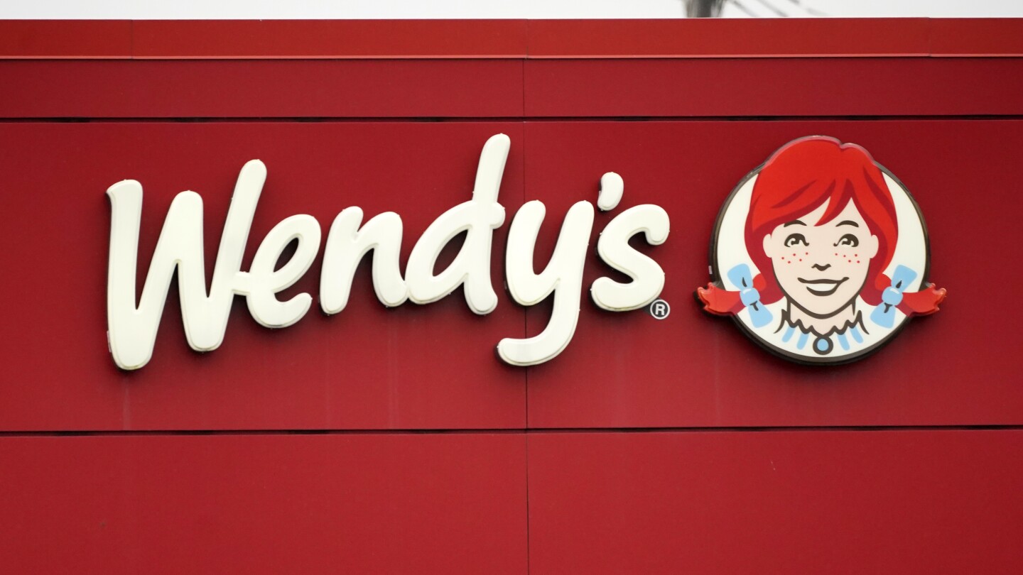 FILE - The Wendy’s sign is seen at a restaurant, Jan. 23, 2023, in Pittsburgh. Wendy’s is looking to test having the prices of its menu items fluc