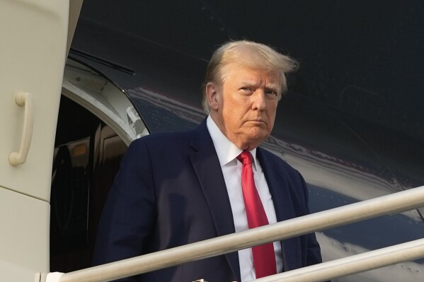 FILE - Former President Donald Trump steps off his plane as he arrives at Hartsfield-Jackson Atlanta International Airport, Thursday, Aug. 24, 2023, in Atlanta. (AP Photo/Alex Brandon, File)