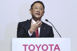 FILE - In this Aug. 4, 2017, file photo, Toyota Motor Corp. President Akio Toyoda answers a question during a joint press conference with Mazda Motor Corp. President Masamichi Kogai in Tokyo. A suicide by a Toyota engineer that was ruled by Japanese authorities as a power harassment case has reached a settlement, the automaker said Monday, June 7, 2021. (AP Photo/Eugene Hoshiko, File)