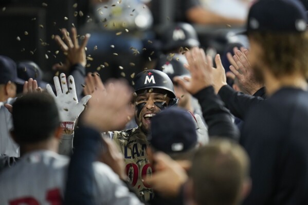 Minnesota Twins designated hitter Royce Lewis, center, celebrates in the dugout after his grand slam during the second inning of a baseball game against the Chicago White Sox, Friday, Sept. 15, 2023, in Chicago. (AP Photo/Erin Hooley)