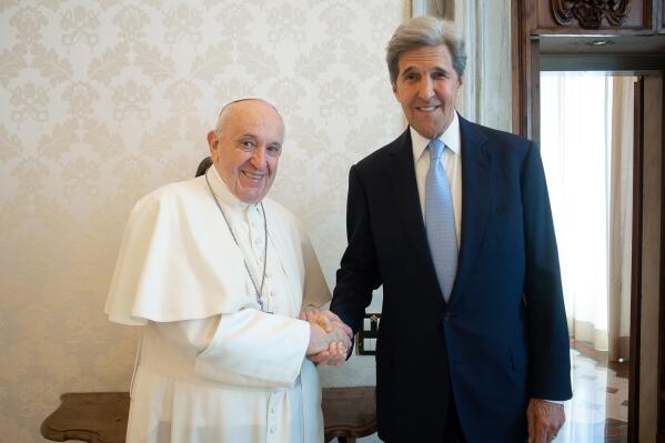 Pope Francis and John Kerry, right, shake hands as they pose for a photo at the Vatican, Saturday, May 15, 2021. Former U.S. Secretary of State John Kerry, currently President Biden’s envoy on the climate, met in private audience with Pope Francis on Saturday, afterward calling the pope “a compelling moral authority on the subject of the climate crisis” who has been “ahead of the curve.” Kerry told Vatican News in an interview that the pope speaks with “unique authority, compelling moral authority, that hopefull can push people to greater ambition to get the job done. (Vatican Media via AP)