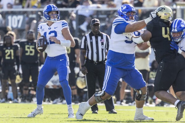 BYU quarterback Jake Retzlaff drops back into pocket against Central Florida during the first half of an NCAA college football game, Saturday, Oct. 26, 2024, in Orlando, Fla. (AP Photo/Kevin Kolczynski)