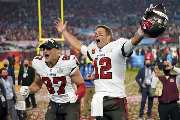 FILE - Tampa Bay Buccaneers tight end Rob Gronkowski, left, and quarterback Tom Brady (12) celebrate after the NFL Super Bowl 55 football game against the Kansas City Chiefs in Tampa, Fla., Feb. 7, 2021. Tom Brady has retired after winning seven Super Bowls and setting numerous passing records in an unprecedented 22-year-career. He made the announcement, Tuesday, Feb. 1, 2022, in a long post on Instagram. (AP Photo/Steve Luciano, File)