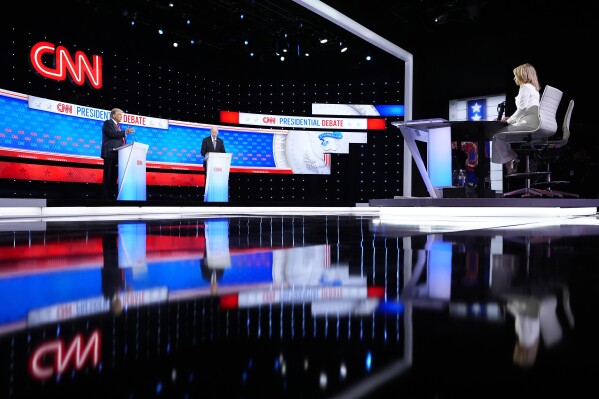 President Joe Biden, right, and Republican presidential candidate former President Donald Trump, left, during a presidential debate hosted by CNN, Thursday, June 27, 2024, in Atlanta. On the far right is CNN moderator Dana Bash. (AP Photo/Gerald Herbert)