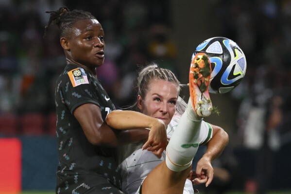 Ireland's Lily Agg, battle for the ball with Nigeria's Uchenna Kanu during the Women's World Cup Group B soccer match between Ireland and Nigeria in Brisbane, Australia, Monday, July 31, 2023. (AP Photo/Tertius Pickard)