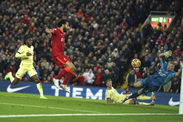 Liverpool's Mohamed Salah scores his side's third goal during the English Premier League soccer match between Liverpool and Arsenal at Anfield Stadium, Liverpool, England, on Nov. 20, 2021. (AP Photo/Jon Super, File)