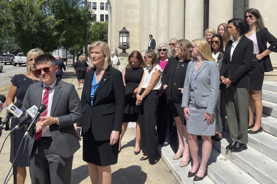 FILE - The legal team for Planned Parenthood South Atlantic speaks outside the South Carolina Supreme Court building in Columbia, S.C. on Tuesday, June 27, 2023. In a complaint filed Thursday, Sept. 14, 2023, the team wrote that a strict new abortion ban should be interpreted to take effect after approximately nine weeks of pregnancy. (AP File Photo/James Pollard, File)
