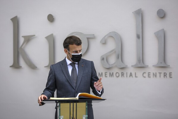 FILE-French President Emmanuel Macron speaks next to the visitor's book at the genocide memorial site in the capital Kigali, Rwanda Thursday, May 27, 2021. French President Emmanuel Macron says France and its allies "could have stopped" the 1994 Rwanda genocide and "lacked the will to do so." Macron's office said in a statement that the French president will release a video on Sunday as Rwanda commemorates the 30th anniversary of the genocide. (AP Photo/Muhizi Olivier, File)