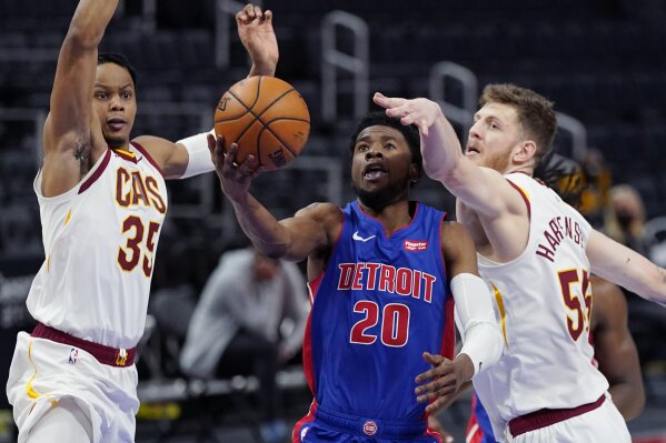Detroit Pistons guard Josh Jackson (20) attempts a layup as Cleveland Cavaliers forward Isaac Okoro (35) and center Isaiah Hartenstein (55) defend during the second half of an NBA basketball game, Monday, April 19, 2021, in Detroit. (AP Photo/Carlos Osorio)