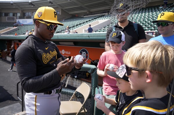 Pittsburgh Pirates second baseman Termarr Johnson signs autographs before a spring training baseball game against the Detroit Tigers Saturday, March 9, 2024, in Lakeland, Fla. (AP Photo/Charlie Neibergall)