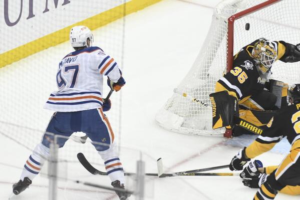 Edmonton Oilers center Connor McDavid (97) scores on Pittsburgh Penguins goalie Tristan Jarry (35) during the first period of an NHL hockey game, Thursday, Feb. 23, 2023, in Pittsburgh. (AP Photo/Philip G. Pavely)