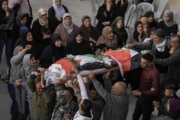 FILE - Palestinians carry the body of Jana Zakaran, 16, during her funeral in the West Bank city of Jenin, Monday, Dec. 12, 2022. Palestinian health officials said Zakaran was killed by Israeli fire during a military operation in the occupied West Bank. Israeli soldiers accused of harming Palestinians in the occupied West Bank and Gaza Strip over the last five years have been indicted in less than 1% of the hundreds of complaints against them, an Israeli rights group reported on Wednesday, Dec. 21, 2022, arguing Israel's military systematically fails to conduct a credible prosecution of itself. (AP Photo/Majdi Mohammed, File)