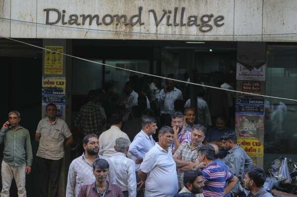 Diamond traders wait for clients at a market in Surat, India, on April 14, 2025. (AP Photo/Ajit Solanki)