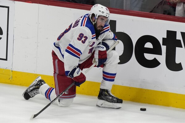 New York Rangers center Mika Zibanejad (93) kneels on the ice after his team lost Game 6 to the Florida Panthers in the Eastern Conference finals of the NHL hockey Stanley Cup playoffs Saturday, June 1, 2024, in Sunrise, Fla. (AP Photo/Lynne Sladky)