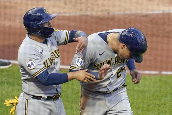 Milwaukee Brewers' Omar Narvaez, left, playfully greets Avisail Garcia, who scored in the Brewers' five-run second inning of a baseball game against the Pittsburgh Pirates, Tuesday, July 27, 2021, in Pittsburgh. (AP Photo/Keith Srakocic)