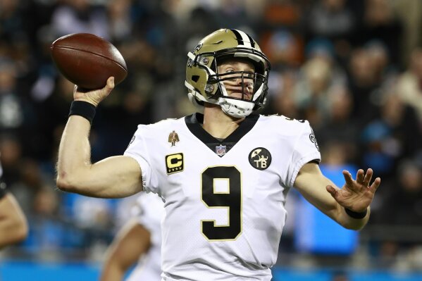 
              FILE - In this Dec. 17, 2018 file photo New Orleans Saints' Drew Brees (9) looks to pass against the Carolina Panthers in the first half of an NFL football game in Charlotte, N.C. Br...