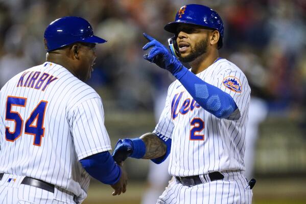 New York Mets' Dominic Smith (2) gestures to fans as he is greeted by first base coach Wayne Kirby (54) after hitting an RBI single during the fifth inning of the team's baseball game against the St. Louis Cardinals on Wednesday, May 18, 2022, in New York. (AP Photo/Frank Franklin II)