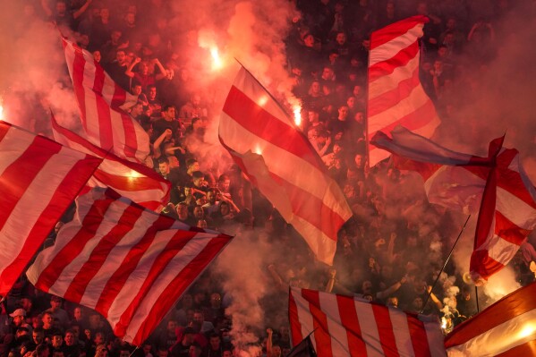 Red Star fans light fireworks during a Serbian National soccer league derby match between Red Star and Partizan in Belgrade, Serbia, Saturday, April 20, 2024. (AP Photo/Darko Vojinovic)