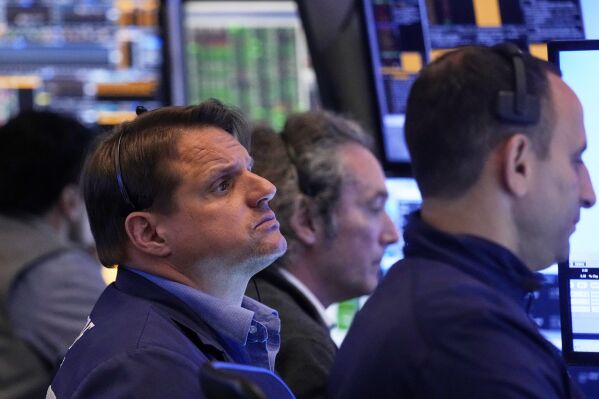 Trader Michael Milano, left, works with colleagues on the floor of the New York Stock Exchange, Tuesday, May 27, 2025. (AP Photo/Richard Drew)