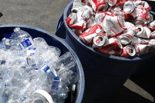FILE - Cans and plastic bottles brought in for recycling fill containers at a recycling center in Sacramento, Calif., July 5, 2016. Gov. Gavin Newsom's administration proposed Friday, April 1, 2022, to temporarily double California's typical nickel refunds for bottles and cans to boost recycling and help spend down a roughly $600 million surplus built up during the coronavirus pandemic. (AP Photo/Rich Pedroncelli, File)