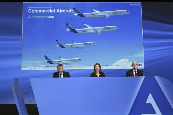 Airbus CEO Guillaume Faury, left, Chief Sustainability officer and Communications Julie Kitcher and Chief Finance Officer Thomas Toepfer present the European aerospace giant full year results, Thursday, Feb. 15, 2024 in Blagnac, near Toulouse, southwestern France. (AP Photo/Fred Scheiber)